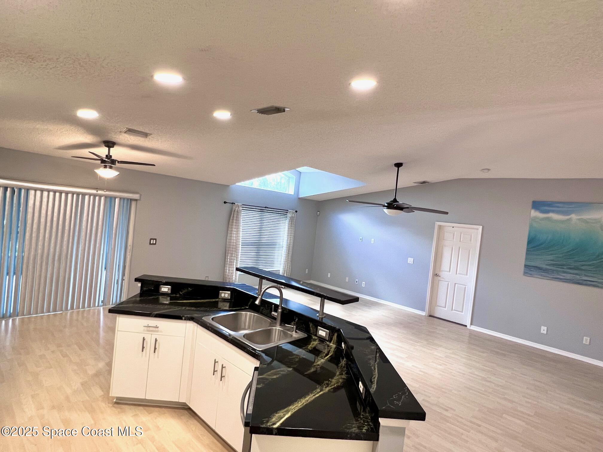 2149 Caledonia Place Melbourne, FL 32940 - Photo 5 of 18 a kitchen with a stove a sink and a refrigerator