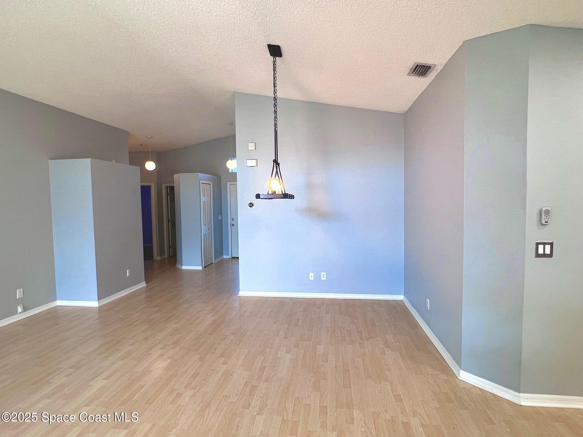 2149 Caledonia Place Melbourne, FL 32940 - Photo 7 of 18 a view of a room with wooden floor and a window