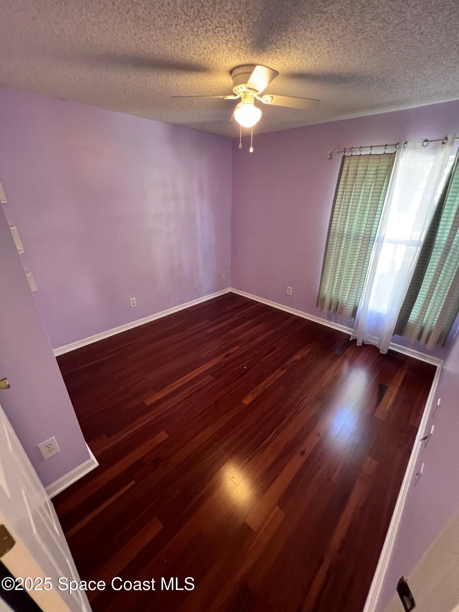 2149 Caledonia Place Melbourne, FL 32940 - Photo 10 of 18 a view of an empty room with a window and chandelier