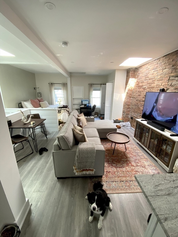 27 Swallow Street, Unit 3 Boston, MA 02127 - Photo 7 of 8 a living room with furniture and wooden floor