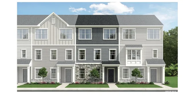 front view of a brick building next to a yard