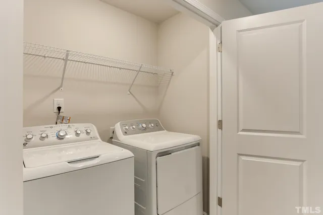 a view of a hallway with wooden floor and entryway