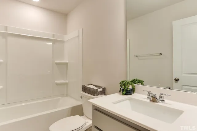 a work room with furniture and paintings on the wall