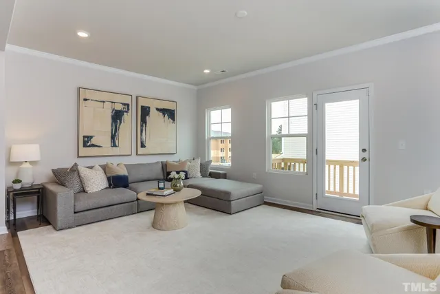 a living room with furniture and kitchen view