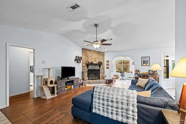 a kitchen with refrigerator and chairs