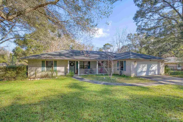 a view of a yard with plants and trees