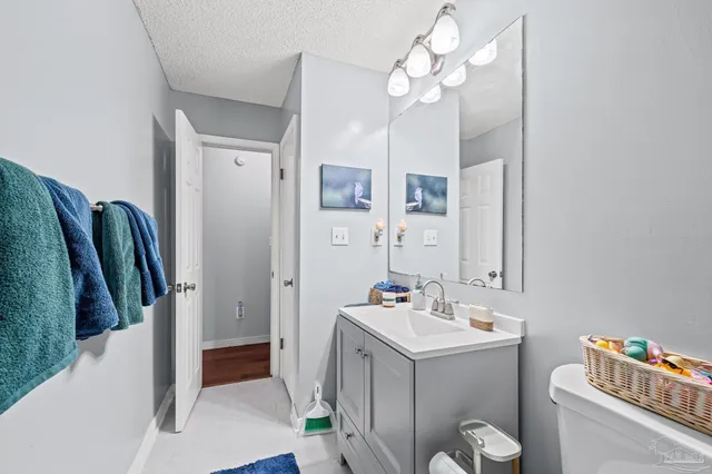 a white toilet sitting next to a shower curtain