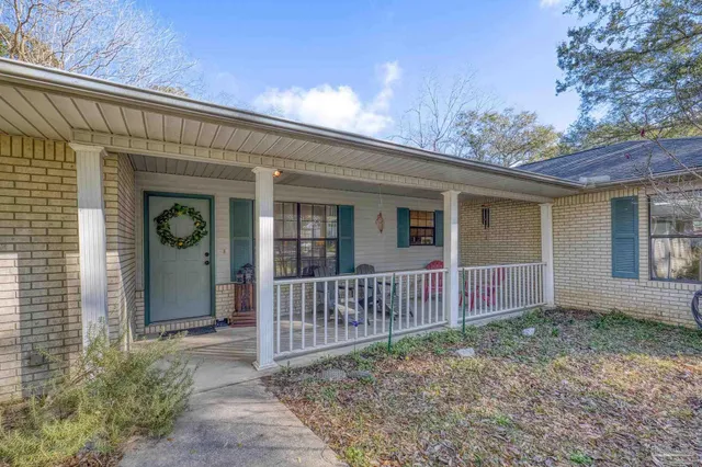 a living room with furniture a fireplace and a chandelier