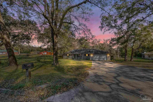 a living room with furniture and floor to ceiling windows