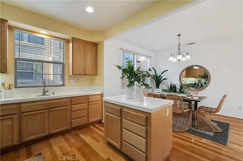a dining hall with granite countertop a sink flowers in it