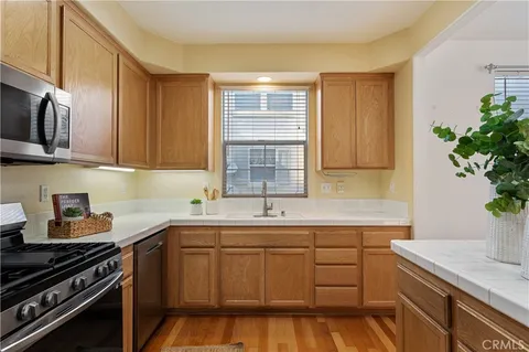 a kitchen with a sink stove and cabinets