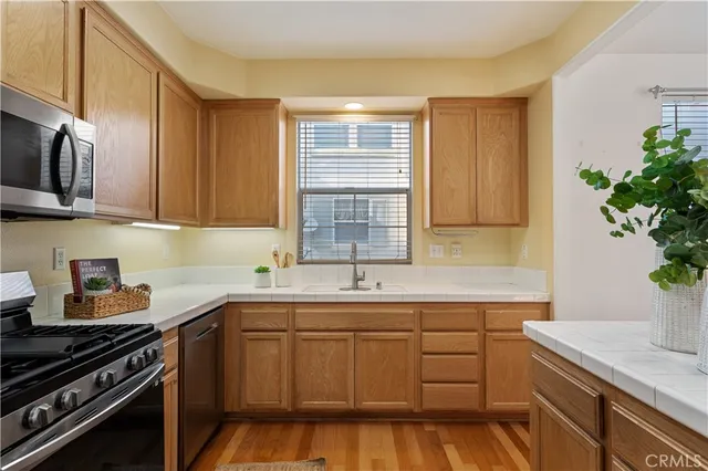 a kitchen with a sink stove and cabinets