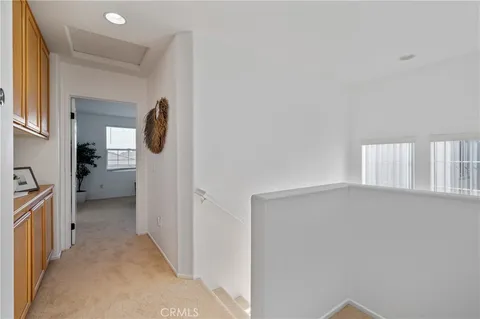 a view of a hallway with a livingroom and a bathroom