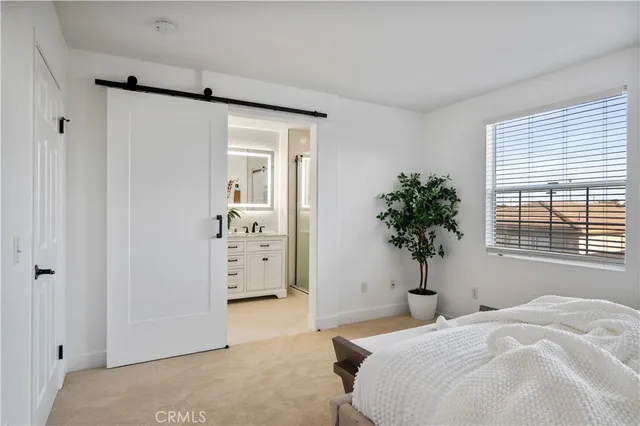 a bedroom with a bed and a potted plant