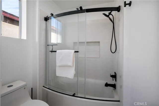 a bathroom with a shower and toilet
