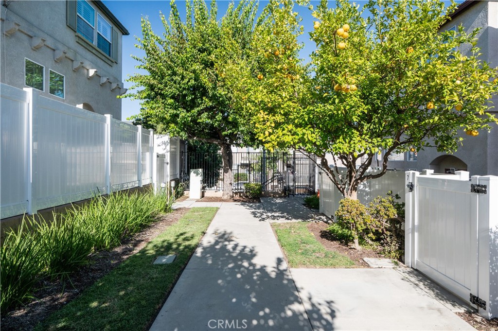 25481 Dodge Avenue, Unit 12 Harbor City, CA 90710 - Photo 3 of 35 a front view of a house with a yard and fountain
