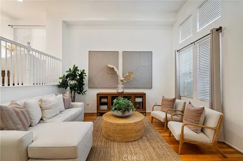 a living room with furniture fireplace and a window