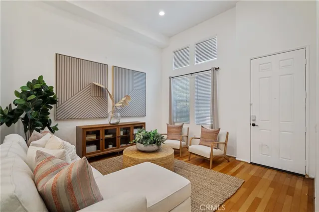 a living room with furniture a fireplace and a potted plant