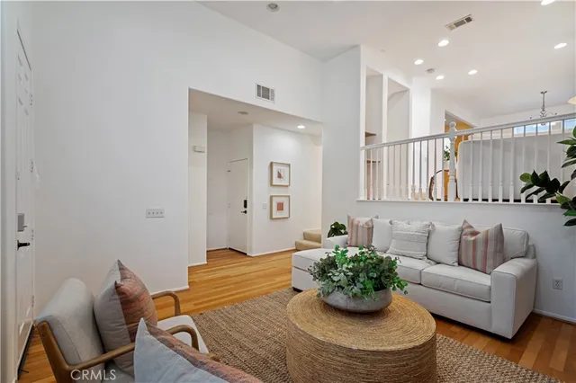 a living room with furniture kitchen and a chandelier