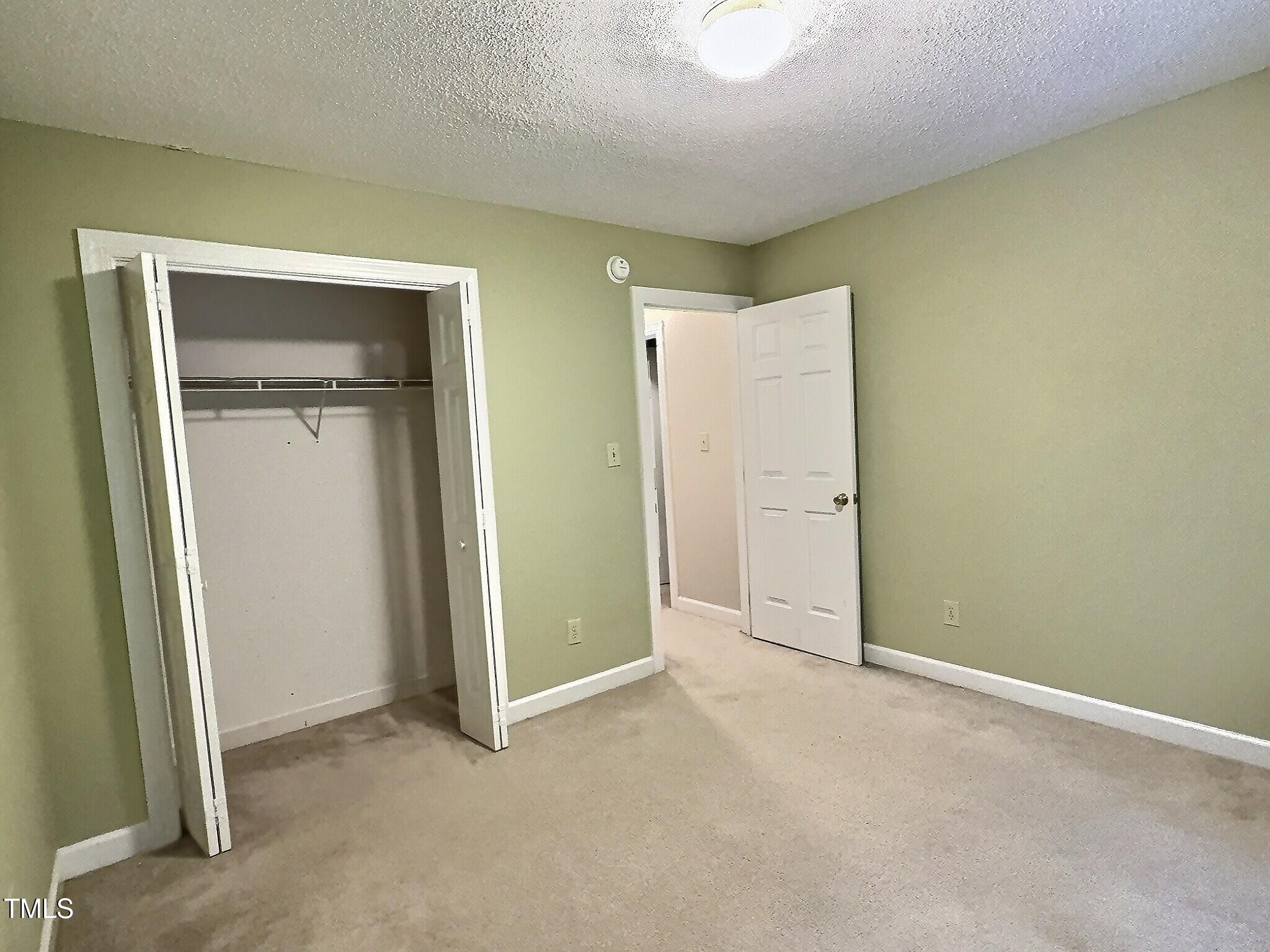 7 Preakness Drive Durham, NC 27713 - Photo 19 of 32 an empty room with closet and a bathroom