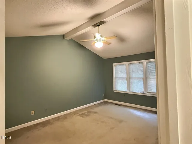 an empty room with a empty space and windows