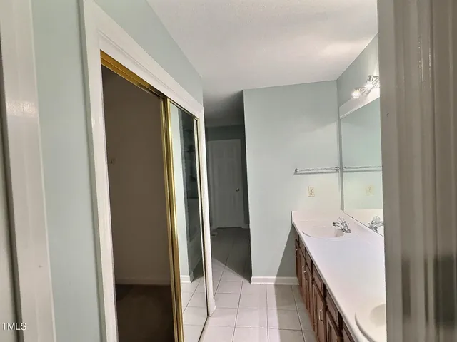 a bathroom with a double vanity sink and mirror