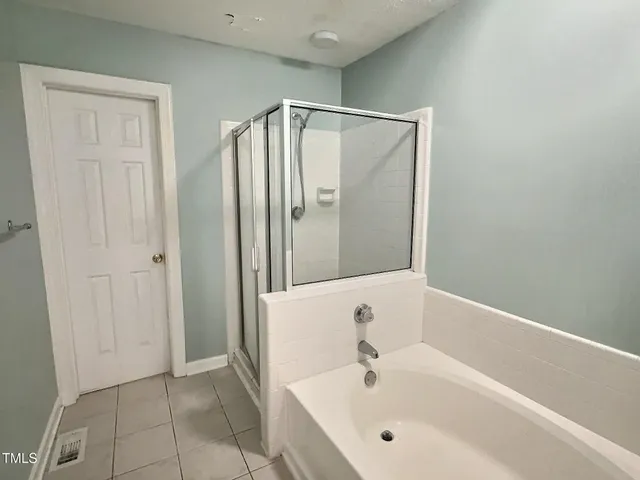 a bathroom with a bathtub and a shower