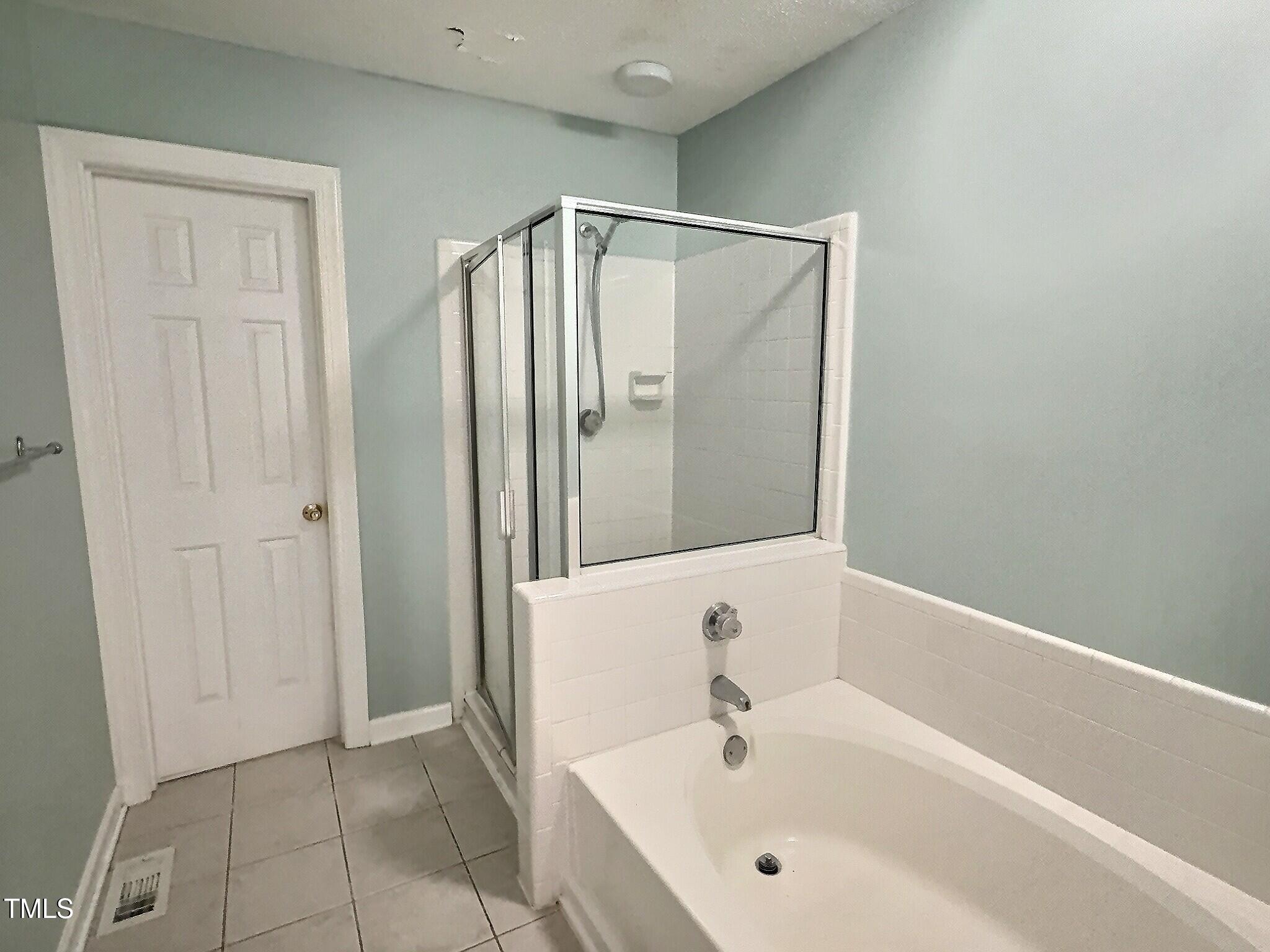 7 Preakness Drive Durham, NC 27713 - Photo 25 of 32 a bathroom with a bathtub and a shower