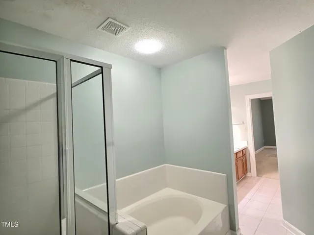 a bathroom with a tub and shower