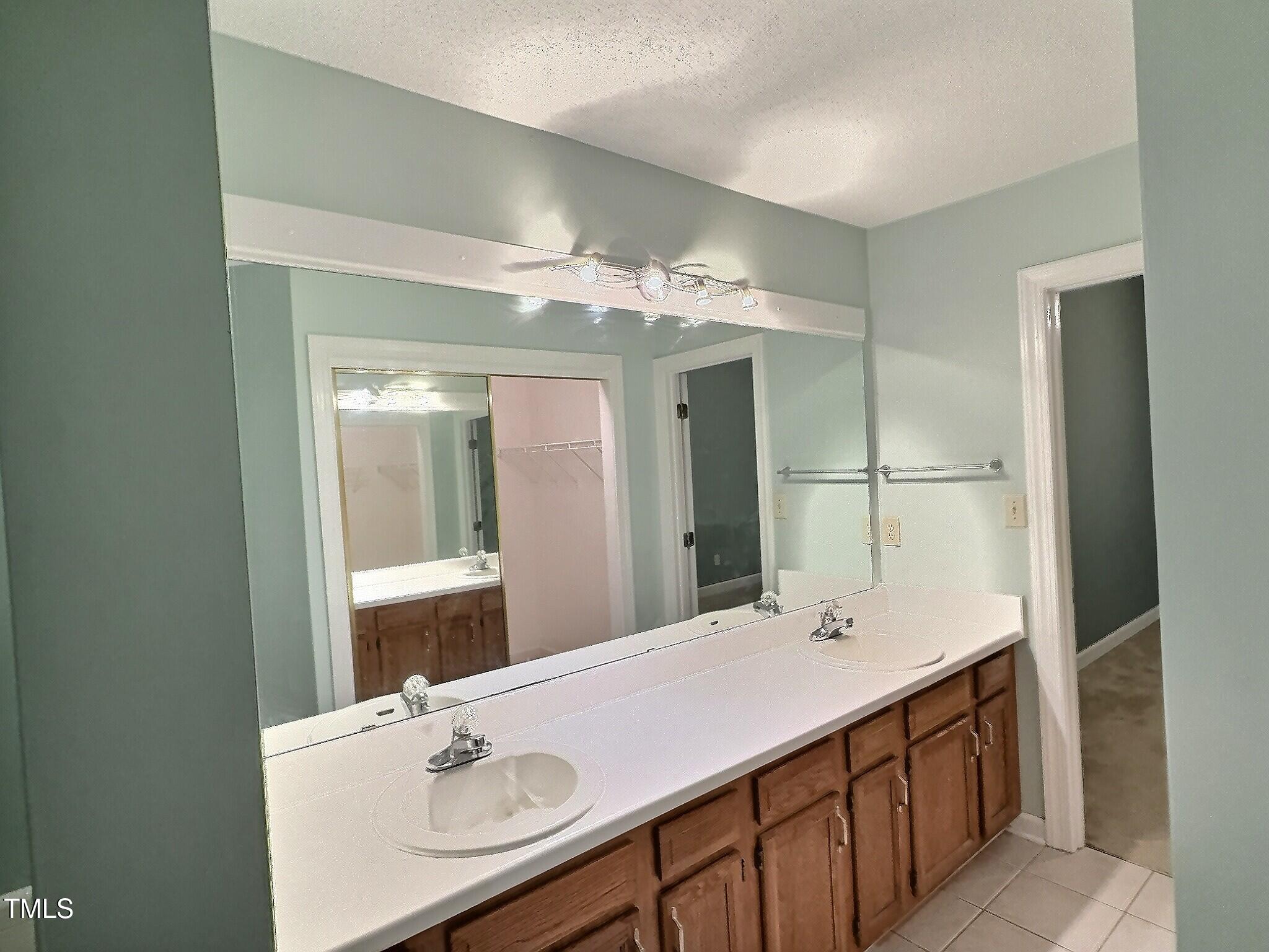 7 Preakness Drive Durham, NC 27713 - Photo 27 of 32 a bathroom with a sink vanity granite tub and a mirror