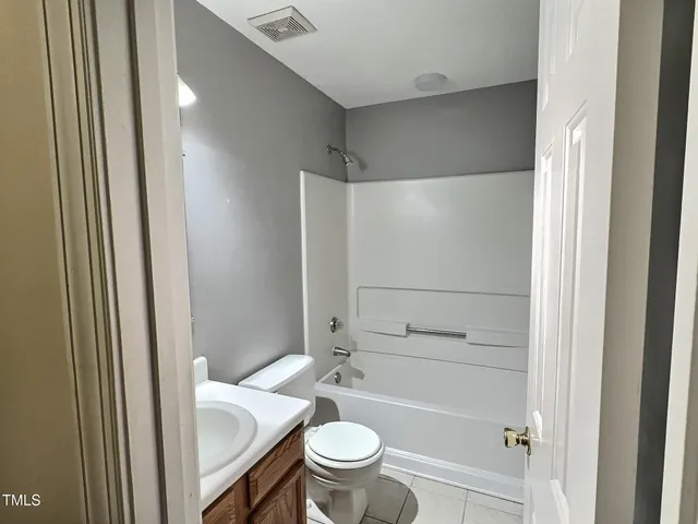 a bathroom with a shower and a toilet