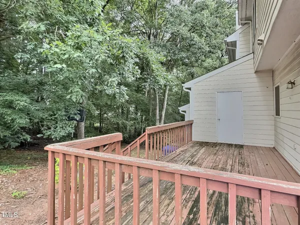 a view of backyard with small cabin and wooden fencing
