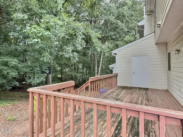 a view of backyard with small cabin and wooden fencing