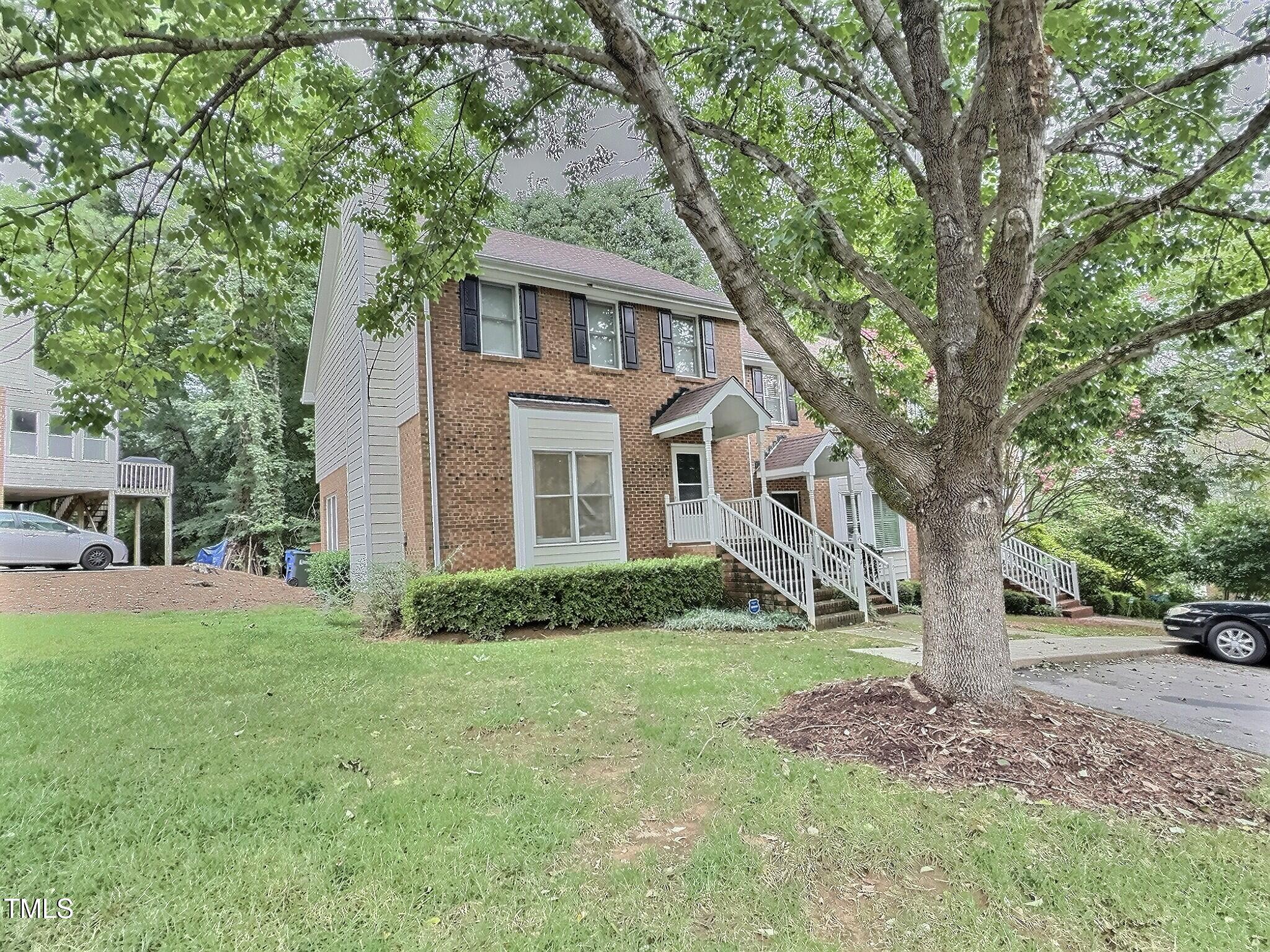 7 Preakness Drive Durham, NC 27713 - Photo 32 of 32 a white house that has a tree in front of it