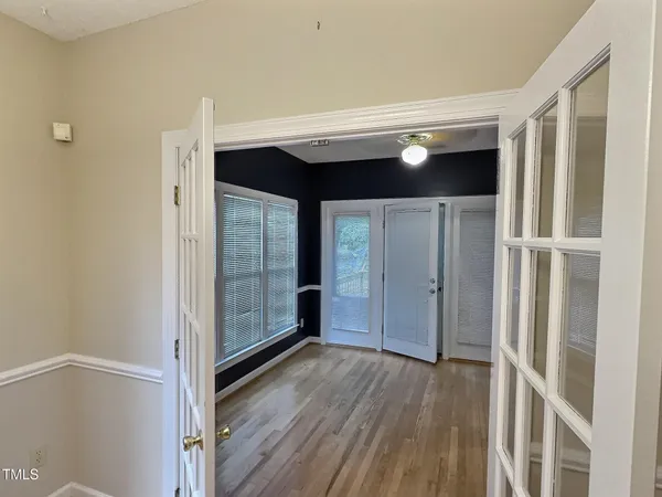 a view of a hallway with wooden floor and entryway