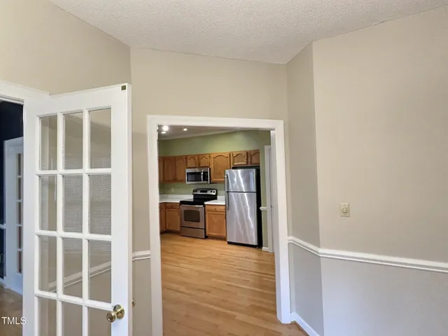 a view of a kitchen with wooden floor and a kitchen