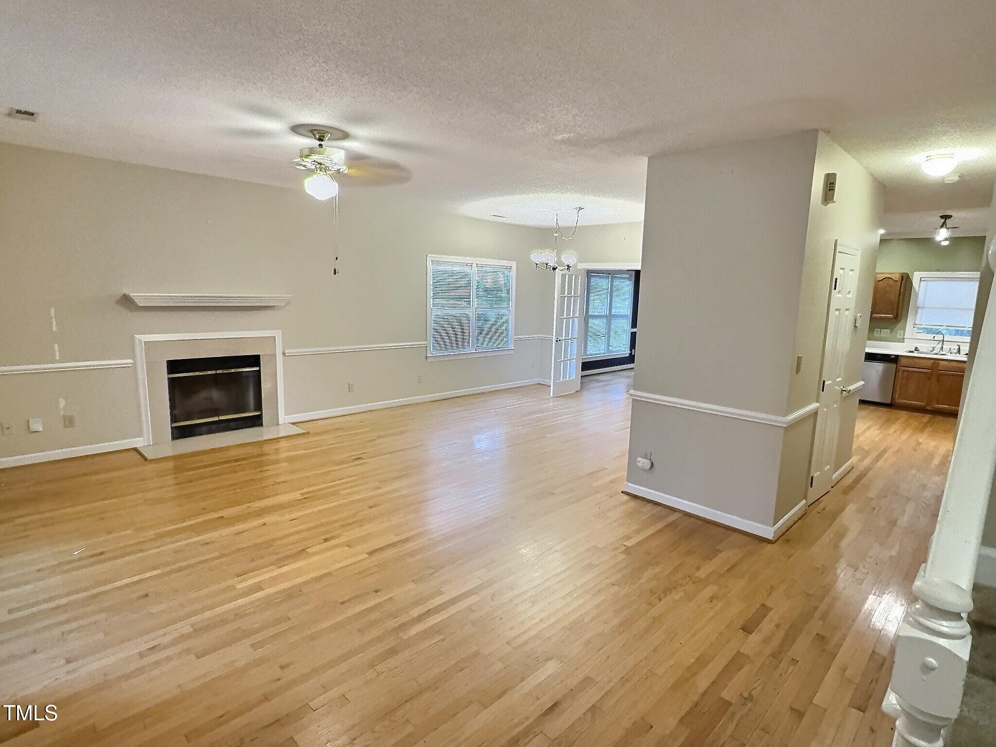 7 Preakness Drive Durham, NC 27713 - Photo 8 of 32 a view of a livingroom with wooden floor and kitchen