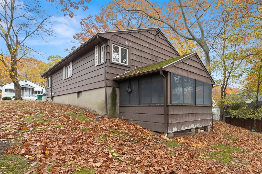 15 Quebec Court Lynn, MA 01905 - Photo 3 of 23 a view of a house with a yard and wooden fence