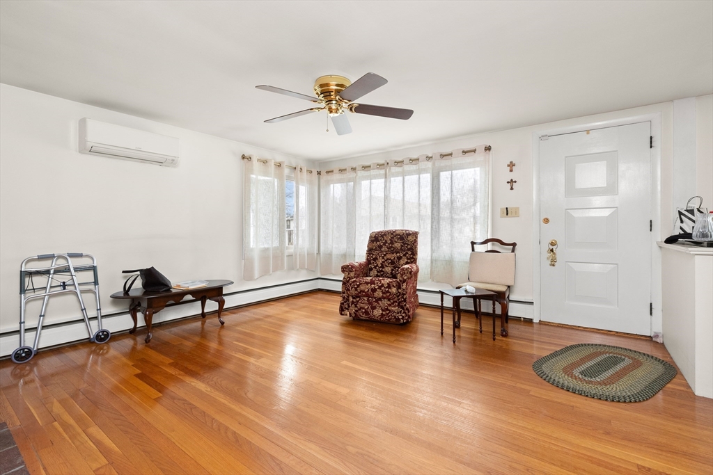 15 Quebec Court Lynn, MA 01905 - Photo 4 of 23 a living room with furniture and a wooden floor