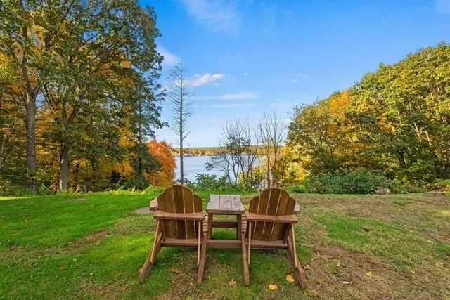 a view of a chairs and table in backyard