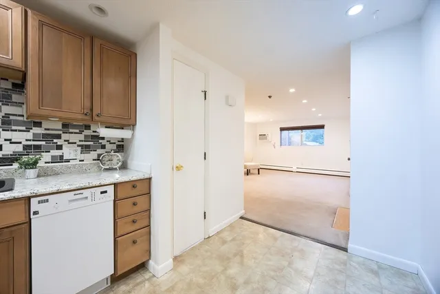 a kitchen with a refrigerator sink and cabinets