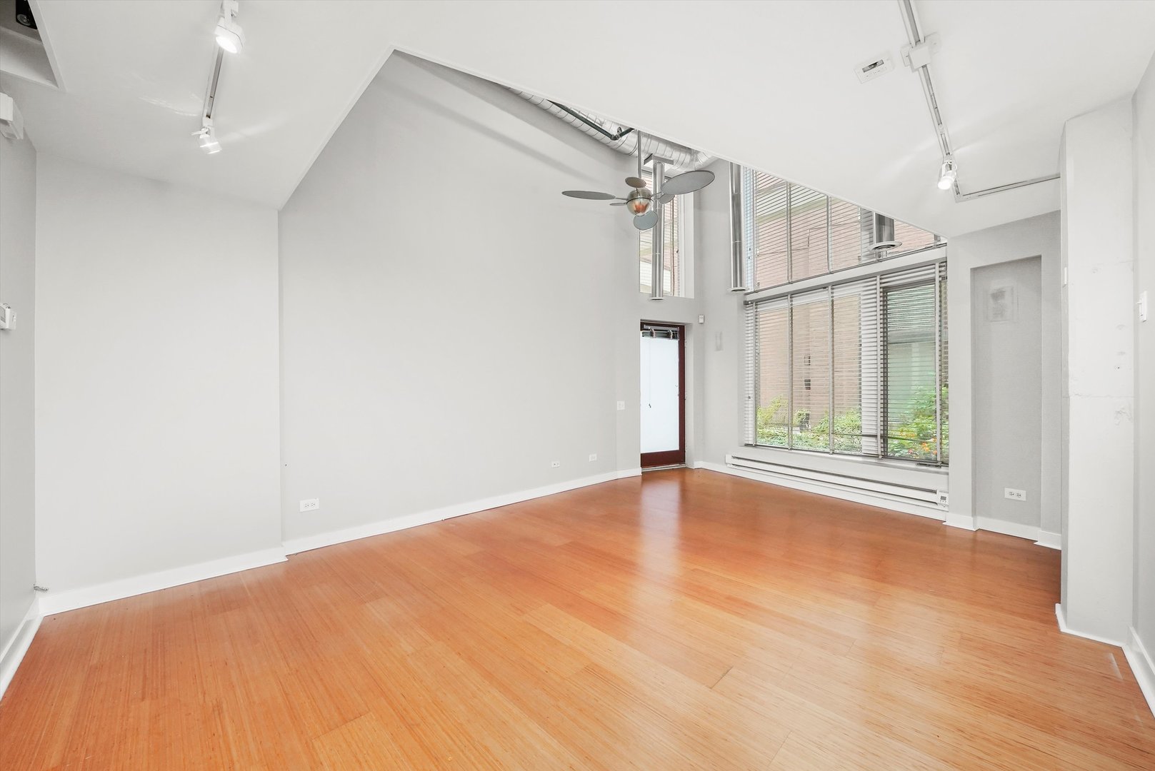 1209 West Cottage Place Chicago, IL 60607 - Photo 4 of 29 a view of empty room with wooden floor and fan