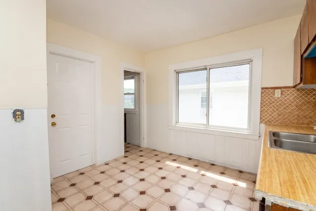 a view of a bedroom with wooden floor and a window