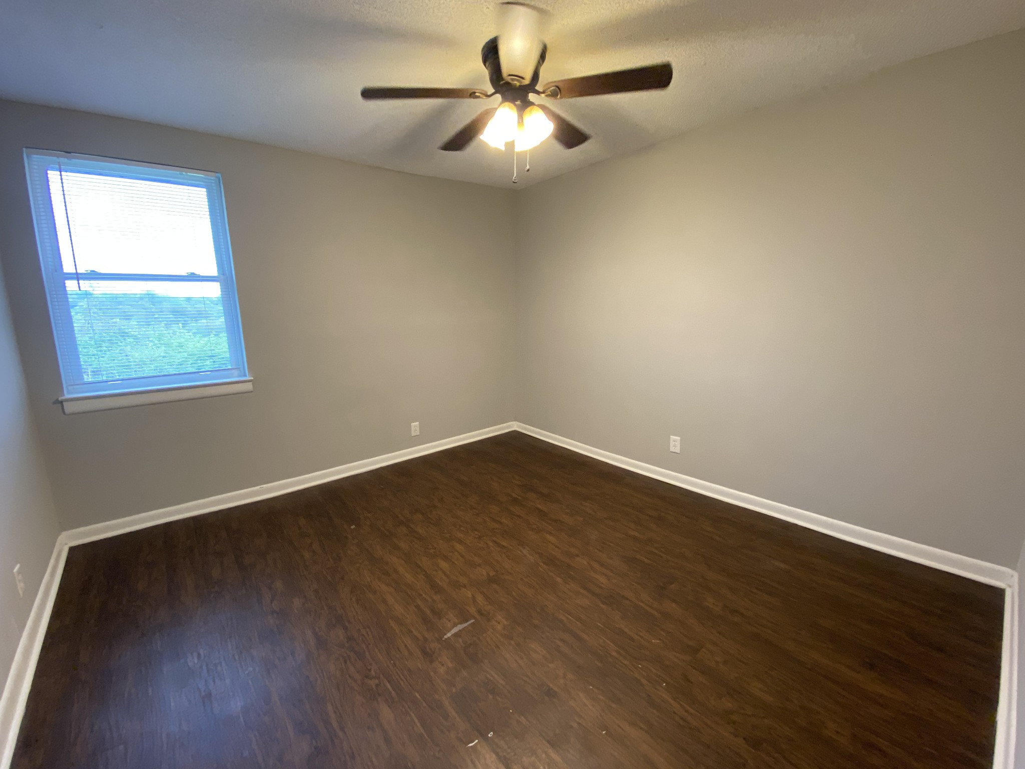 4674 Forest Ridge Drive Hermitage, TN 37076 - Photo 13 of 19 an empty room with wooden floor chandelier fan and windows