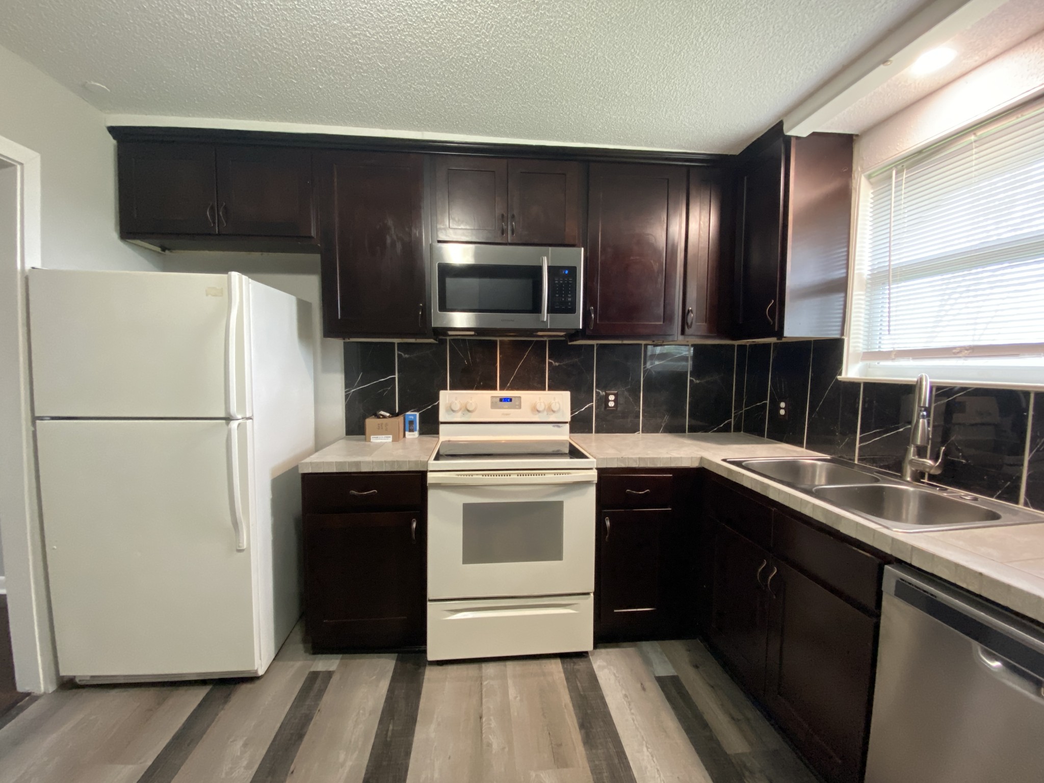 4674 Forest Ridge Drive Hermitage, TN 37076 - Photo 7 of 19 a kitchen with a sink and a refrigerator