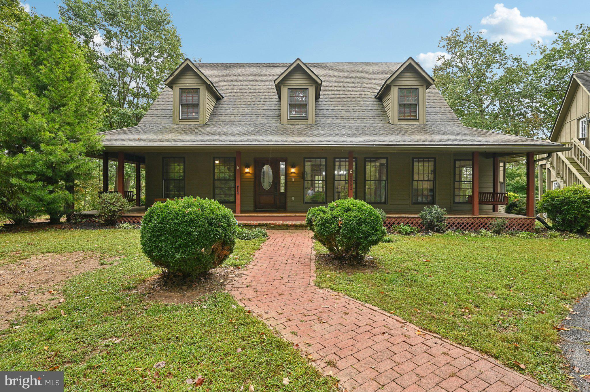 2862 Cox Ridge Road Westminster, MD 21157 - Photo 3 of 64 a view of a white house with a yard and potted plants