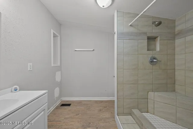 a bathroom with a bathtub and shower