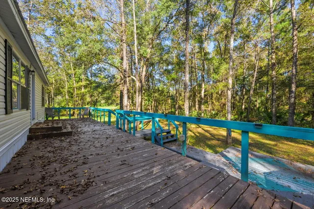 a view of a wooden deck with a yard