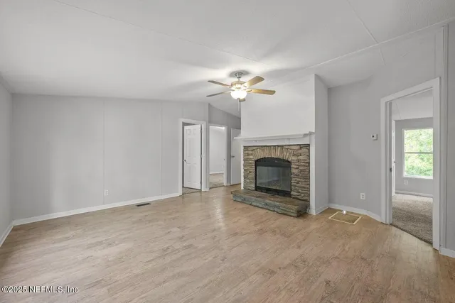 a view of an empty room with a fireplace