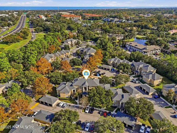 an aerial view of residential houses with outdoor space